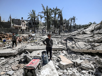 Palestinians are inspecting the damage in the rubble of Abu Bakr Al-Siddiq Mosque, which was leveled by Israeli bombardment in Deir Al-Balah...