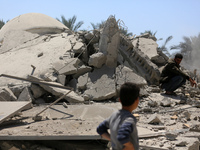 Palestinians are inspecting the damage in the rubble of Abu Bakr Al-Siddiq Mosque, which was leveled by Israeli bombardment in Deir Al-Balah...