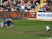 Goalkeeper Will Mannion of Cambridge United is watching the ball as it bounces off the post during the Sky Bet League 1 match between Cambri...