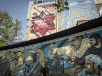 An Iranian woman is walking under anti-Israeli murals in downtown Tehran, Iran, on April 13, 2024. The Prime Minister of Israel, Benjamin Ne...