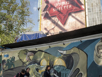 Young Iranian women are walking under anti-Israeli murals in downtown Tehran, Iran, on April 13, 2024. The Prime Minister of Israel, Benjami...