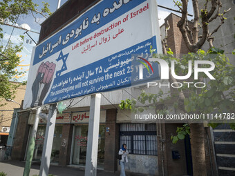 An Iranian woman is walking under an anti-Israeli billboard in downtown Tehran, Iran, on April 13, 2024. The Prime Minister of Israel, Benja...