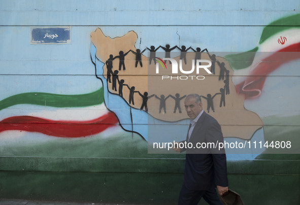 An Iranian man is walking past a mural in downtown Tehran, Iran, on April 13, 2024. The Prime Minister of Israel, Benjamin Netanyahu, is thr...