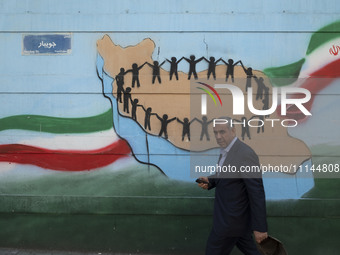 An Iranian man is walking past a mural in downtown Tehran, Iran, on April 13, 2024. The Prime Minister of Israel, Benjamin Netanyahu, is thr...