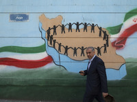 An Iranian man is walking past a mural in downtown Tehran, Iran, on April 13, 2024. The Prime Minister of Israel, Benjamin Netanyahu, is thr...