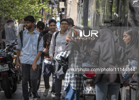 Young Iranian art students are standing together on a sidewalk near an art university in downtown Tehran, Iran, on April 13, 2024. The Prime...