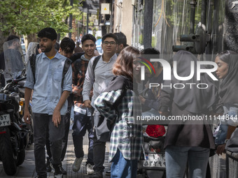 Young Iranian art students are standing together on a sidewalk near an art university in downtown Tehran, Iran, on April 13, 2024. The Prime...