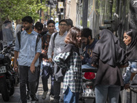 Young Iranian art students are standing together on a sidewalk near an art university in downtown Tehran, Iran, on April 13, 2024. The Prime...