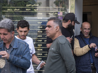 Iranian street money changers are standing outside a currency exchange shop in Tehran's business district, Iran, on April 13, 2024. Meanwhil...