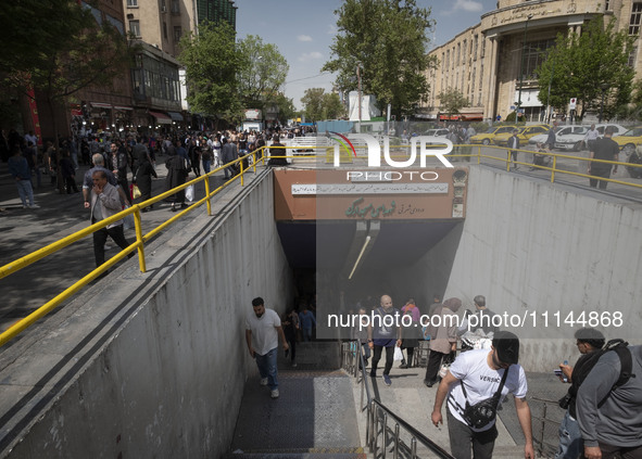 Iranian shoppers are walking out of an underground station near the Grand Bazaar in southern Tehran, Iran, on April 13, 2024. The Prime Mini...