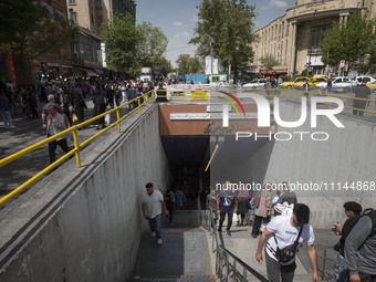 Iranian shoppers are walking out of an underground station near the Grand Bazaar in southern Tehran, Iran, on April 13, 2024. The Prime Mini...