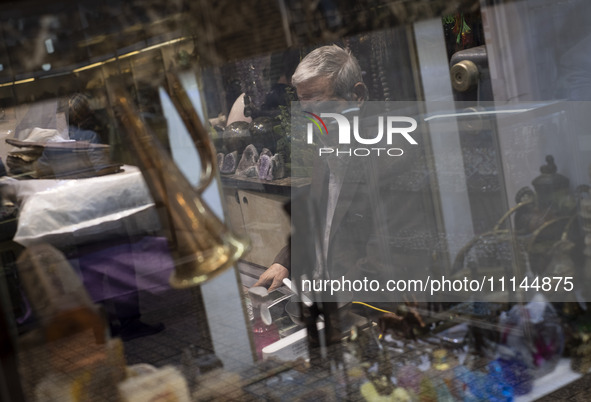 An Iranian trader is sitting at his antique shop in the Grand Bazaar in southern Tehran, Iran, on April 13, 2024. Meanwhile, the Prime Minis...