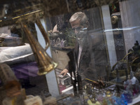 An Iranian trader is sitting at his antique shop in the Grand Bazaar in southern Tehran, Iran, on April 13, 2024. Meanwhile, the Prime Minis...