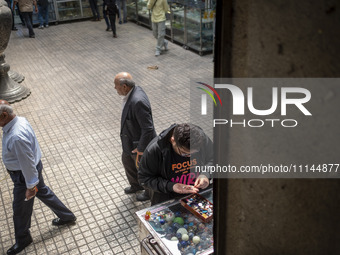 An Iranian man is looking at gemstones while shopping at the Grand Bazaar in southern Tehran, Iran, on April 13, 2024. Meanwhile, the Prime...