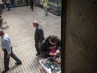 An Iranian man is looking at gemstones while shopping at the Grand Bazaar in southern Tehran, Iran, on April 13, 2024. Meanwhile, the Prime...