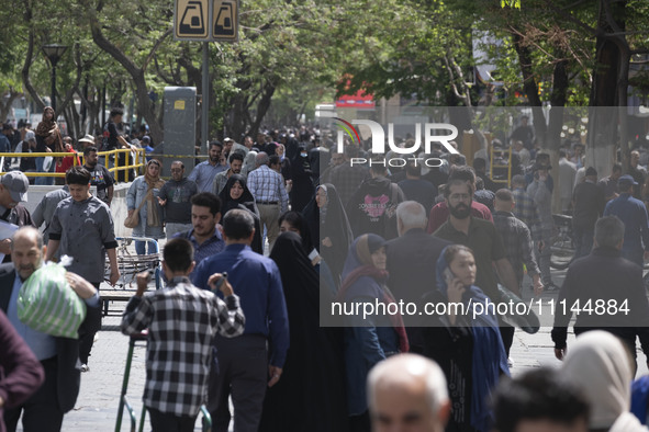 Iranian shoppers are walking along a street near the Grand Bazaar in southern Tehran, Iran, on April 13, 2024. The Prime Minister of Israel,...