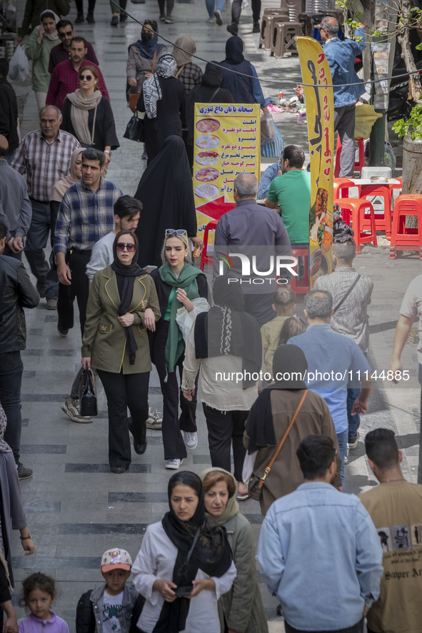 Iranian shoppers are walking along a street near the Grand Bazaar in southern Tehran, Iran, on April 13, 2024. The Prime Minister of Israel,...