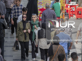 Iranian shoppers are walking along a street near the Grand Bazaar in southern Tehran, Iran, on April 13, 2024. The Prime Minister of Israel,...