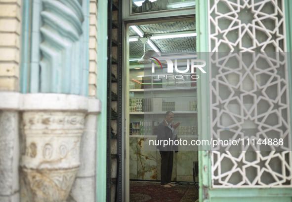 An Iranian man is praying at a small mosque near the Grand Bazaar in southern Tehran, Iran, on April 13, 2024. Meanwhile, the Prime Minister...