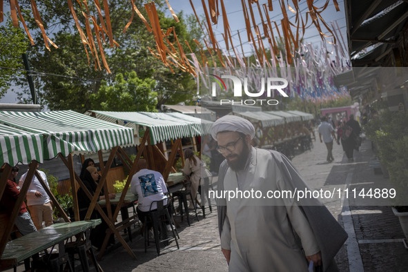 An Iranian cleric is walking along a street near the Grand Bazaar in southern Tehran, Iran, on April 13, 2024. Meanwhile, the Prime Minister...