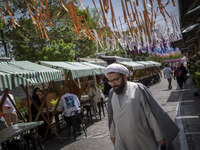 An Iranian cleric is walking along a street near the Grand Bazaar in southern Tehran, Iran, on April 13, 2024. Meanwhile, the Prime Minister...