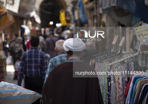 An Iranian cleric is walking along a street near the Grand Bazaar in southern Tehran, Iran, on April 13, 2024. Meanwhile, the Prime Minister...