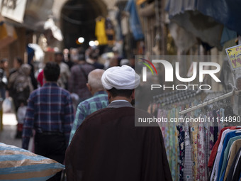 An Iranian cleric is walking along a street near the Grand Bazaar in southern Tehran, Iran, on April 13, 2024. Meanwhile, the Prime Minister...