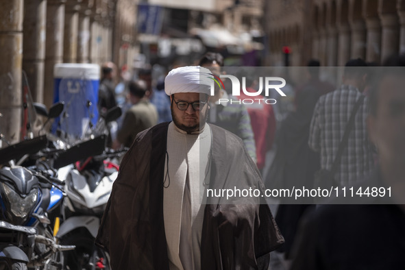 An Iranian cleric is walking along a street near the Grand Bazaar in southern Tehran, Iran, on April 13, 2024. Meanwhile, the Prime Minister...