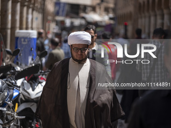 An Iranian cleric is walking along a street near the Grand Bazaar in southern Tehran, Iran, on April 13, 2024. Meanwhile, the Prime Minister...