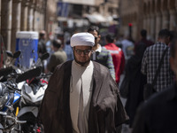 An Iranian cleric is walking along a street near the Grand Bazaar in southern Tehran, Iran, on April 13, 2024. Meanwhile, the Prime Minister...