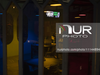 A young Iranian woman is sitting at a cafe in downtown Tehran, Iran, on April 13, 2024. The Prime Minister of Israel, Benjamin Netanyahu, is...