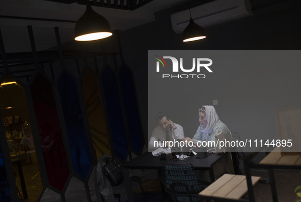 An Iranian man and a woman are sitting together at a cafe in downtown Tehran, Iran, on April 13, 2024. The Prime Minister of Israel, Benjami...