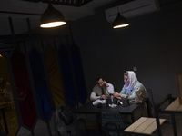 An Iranian man and a woman are sitting together at a cafe in downtown Tehran, Iran, on April 13, 2024. The Prime Minister of Israel, Benjami...