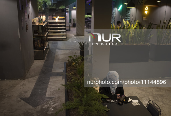 A veiled Iranian woman is sitting at a cafe in downtown Tehran, Iran, on April 13, 2024. The Prime Minister of Israel, Benjamin Netanyahu, i...