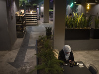 A veiled Iranian woman is sitting at a cafe in downtown Tehran, Iran, on April 13, 2024. The Prime Minister of Israel, Benjamin Netanyahu, i...