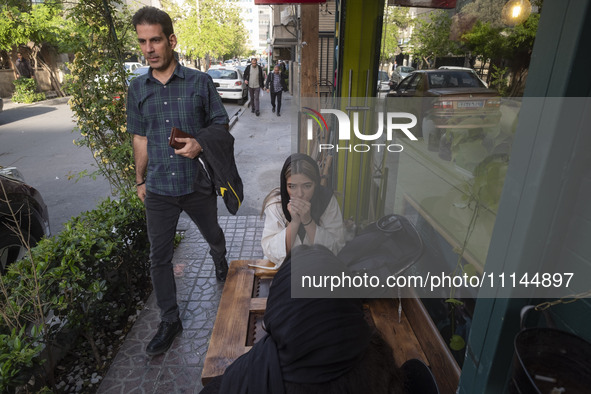 Two young Iranian women are sitting at an outdoor cafe in downtown Tehran, Iran, on April 13, 2024. The Prime Minister of Israel, Benjamin N...