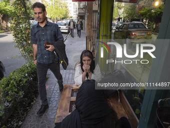 Two young Iranian women are sitting at an outdoor cafe in downtown Tehran, Iran, on April 13, 2024. The Prime Minister of Israel, Benjamin N...