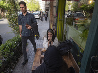 Two young Iranian women are sitting at an outdoor cafe in downtown Tehran, Iran, on April 13, 2024. The Prime Minister of Israel, Benjamin N...