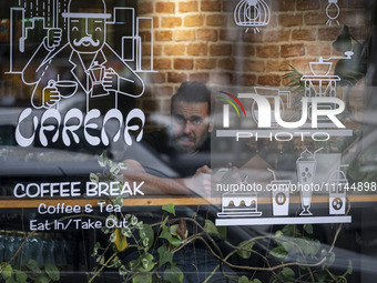 An Iranian man is sitting at a cafe and looking on in downtown Tehran, Iran, on April 13, 2024. The Prime Minister of Israel, Benjamin Netan...