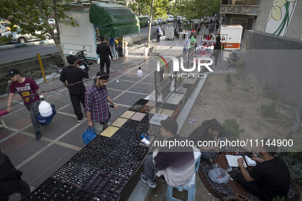 An Iranian man is standing next to a vendor on a sidewalk in downtown Tehran, Iran, on April 13, 2024. The Prime Minister of Israel, Benjami...