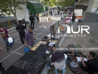 An Iranian man is standing next to a vendor on a sidewalk in downtown Tehran, Iran, on April 13, 2024. The Prime Minister of Israel, Benjami...