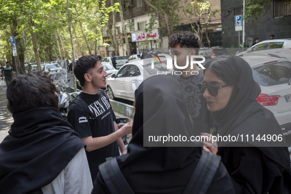 Iranian art students are standing together on a sidewalk in downtown Tehran, Iran, on April 13, 2024. The Prime Minister of Israel, Benjamin...