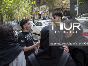 Iranian art students are standing together on a sidewalk in downtown Tehran, Iran, on April 13, 2024. The Prime Minister of Israel, Benjamin...