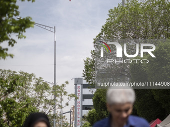 People in Tehran, Iran, are walking under a massive Iranian flag in downtown on April 13, 2024. The Prime Minister of Israel, Benjamin Netan...