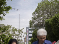 People in Tehran, Iran, are walking under a massive Iranian flag in downtown on April 13, 2024. The Prime Minister of Israel, Benjamin Netan...