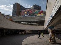 An Iranian woman is walking under a massive banner featuring an image of the al-Aqsa mosque in downtown Tehran, Iran, on April 13, 2024. The...