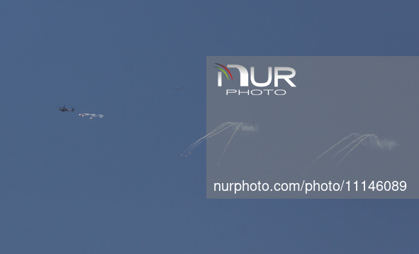 An Israeli Air Force attack helicopter is releasing flares during a flyover above the Gaza Strip on April 14, 2024, amid ongoing battles in...