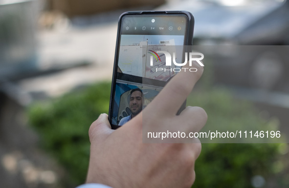 An Iranian man is taking a selfie with an anti-Israeli mural in downtown Tehran, Iran, on April 14, 2024. The mural celebrates the IRGC miss...