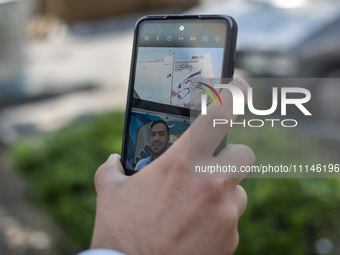 An Iranian man is taking a selfie with an anti-Israeli mural in downtown Tehran, Iran, on April 14, 2024. The mural celebrates the IRGC miss...