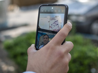 An Iranian man is taking a selfie with an anti-Israeli mural in downtown Tehran, Iran, on April 14, 2024. The mural celebrates the IRGC miss...